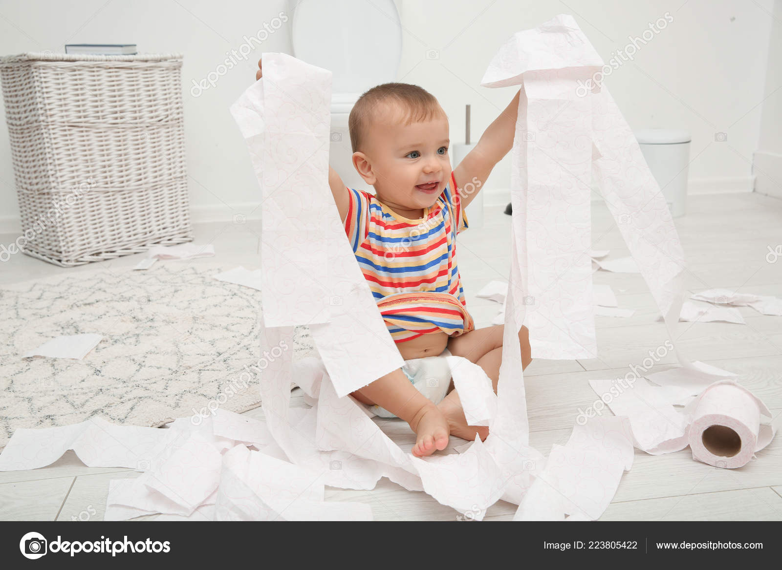 baby playing with toilet brush Cute toddler playing with toilet paper stock image