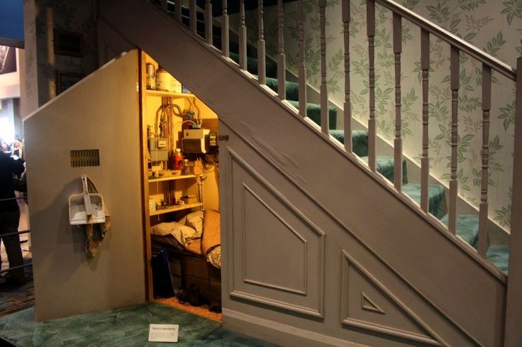 harry potter bedroom under stairs An open door leading to a bed in a room with blue carpet and wallpaper